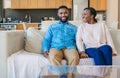 Smiling young African American couple relaxing on their sofa Royalty Free Stock Photo