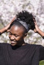 African girl with closed eyes in park in spring Royalty Free Stock Photo