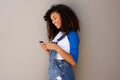 Portrait of smiling young african american woman looking at cellphone Royalty Free Stock Photo