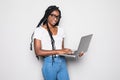 Portrait of smiling young afro american woman holding laptop computer over white background Royalty Free Stock Photo