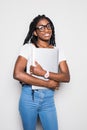 Portrait of smiling young afro american woman using laptop computer while walking over white background Royalty Free Stock Photo