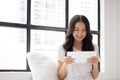 Portrait of a smiling young asian beautiful girls are shopping online with credit card in the living room Royalty Free Stock Photo