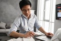 Portrait of a smiling young asian man using laptop computer Royalty Free Stock Photo