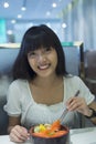 Portrait of smiling young asian woman eating japanese food Royalty Free Stock Photo