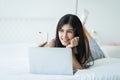 Portrait of a smiling young asian woman making selfie on smartphone in the bed at home, Technology, social media and online Royalty Free Stock Photo