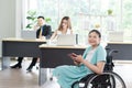 Portrait of Smiling young Asian woman office worker in wheelchair holding tablet look at camera, disabled people working with Royalty Free Stock Photo