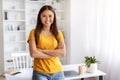 Portrait Of Smiling Young Asian Woman Standing With Folded Arms Near Desk Royalty Free Stock Photo