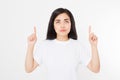 Portrait of smiling young asian woman wearing summer t shirt pointing at copy space by finger isolated on white blank background Royalty Free Stock Photo