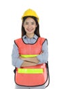 Portrait of smiling young beautiful Asian female engineer with long dark brown hair wearing safety helmet standing with arms Royalty Free Stock Photo
