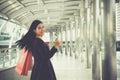 Portrait of smiling young beautiful woman holding shopping bags Royalty Free Stock Photo