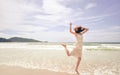 Portrait of smiling young beautiful woman jumping on the beach Royalty Free Stock Photo