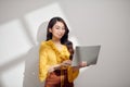 Portrait of a smiling young blonde girl holding laptop computer isolated over white background Royalty Free Stock Photo