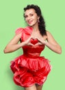 Portrait of a smiling young brunet woman in red dress, s Royalty Free Stock Photo