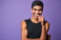 Portrait of smiling young brunette man in black t-shirt and cap. Happy latino model of trans gender Royalty Free Stock Photo