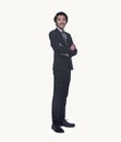 Portrait of smiling young businessman with arms crossed, full length, studio shot Royalty Free Stock Photo