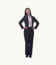 Portrait of smiling young businesswoman with hands on hips looking at camera, full length, studio shot Royalty Free Stock Photo