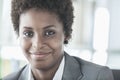 Portrait of smiling young businesswoman with short hair looking at the camera, head and shoulders Royalty Free Stock Photo