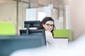 Portrait of smiling young businesswoman wearing headset in office Royalty Free Stock Photo