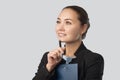 Portrait of a smiling young businesswoman wears a formal business suit working. She holds a folder with documents