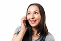 Portrait of a smiling young casual brunette woman talking on mobile phone over white background isolate Royalty Free Stock Photo