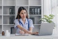 Portrait of smiling young Caucasian female doctor or nurse in white medical uniform in clinic Royalty Free Stock Photo