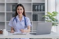 Portrait of smiling young Caucasian female doctor or nurse in white medical uniform in clinic Royalty Free Stock Photo