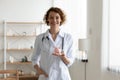 Portrait of smiling female doctor hold piggybank