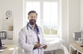 Portrait of smiling male doctor in white medical uniform Royalty Free Stock Photo