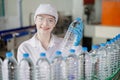 Portrait smiling young caucasian women worker with drink bottles work at factory production line drinking water plant quality Royalty Free Stock Photo