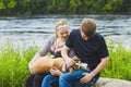 Portrait of smiling young couple patting their dog
