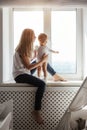 Portrait of a smiling young cute mother and her son playing Royalty Free Stock Photo