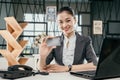 Portrait of a smiling young employee girl holding a debit card in the office Royalty Free Stock Photo