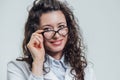 Portrait of smiling young female doctor. Beautiful brunette in white medical gown in glasses. Holding without a Royalty Free Stock Photo