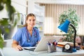 Smiling young female doctor working with laptop in office Royalty Free Stock Photo