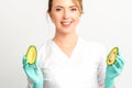 Portrait of smiling young female nutritionist doctor with organic avocado fruits posing at camera on white background Royalty Free Stock Photo
