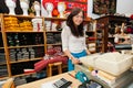 Portrait of smiling young female salesperson at checkout stand in gift store