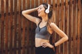 Portrait of a smiling young fitness girl listening to music Royalty Free Stock Photo