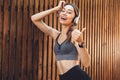 Portrait of a smiling young fitness girl listening to music Royalty Free Stock Photo