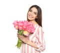 Portrait of smiling young girl with beautiful tulips on white background. Royalty Free Stock Photo