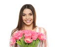 Portrait of smiling young girl with beautiful tulips on white background. Royalty Free Stock Photo