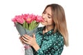 Portrait of smiling young girl with beautiful tulips on white background. Royalty Free Stock Photo