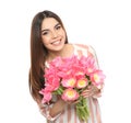 Portrait of smiling young girl with beautiful tulips on white background. Royalty Free Stock Photo