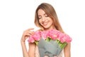 Portrait of smiling young girl with beautiful tulips on white background. Royalty Free Stock Photo