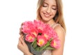 Portrait of smiling young girl with beautiful tulips on white background. Royalty Free Stock Photo