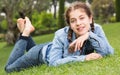 portrait of smiling young girl while lying in outdoors Royalty Free Stock Photo