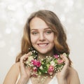 Portrait of a smiling young girl in a necklace of roses