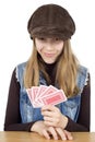 Portrait Of Smiling Young Girl Playing Cards And Looking At The Camera, She Is Very Pleased With The Winning Cards In Her Hand Royalty Free Stock Photo