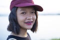 Portrait smiling young girl wear red hat with river view Royalty Free Stock Photo