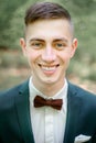 Portrait of smiling young groom wearing green jacket Royalty Free Stock Photo