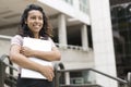 Portrait of smiling young hispanic woman holding laptop computer in her hands outdoors Royalty Free Stock Photo